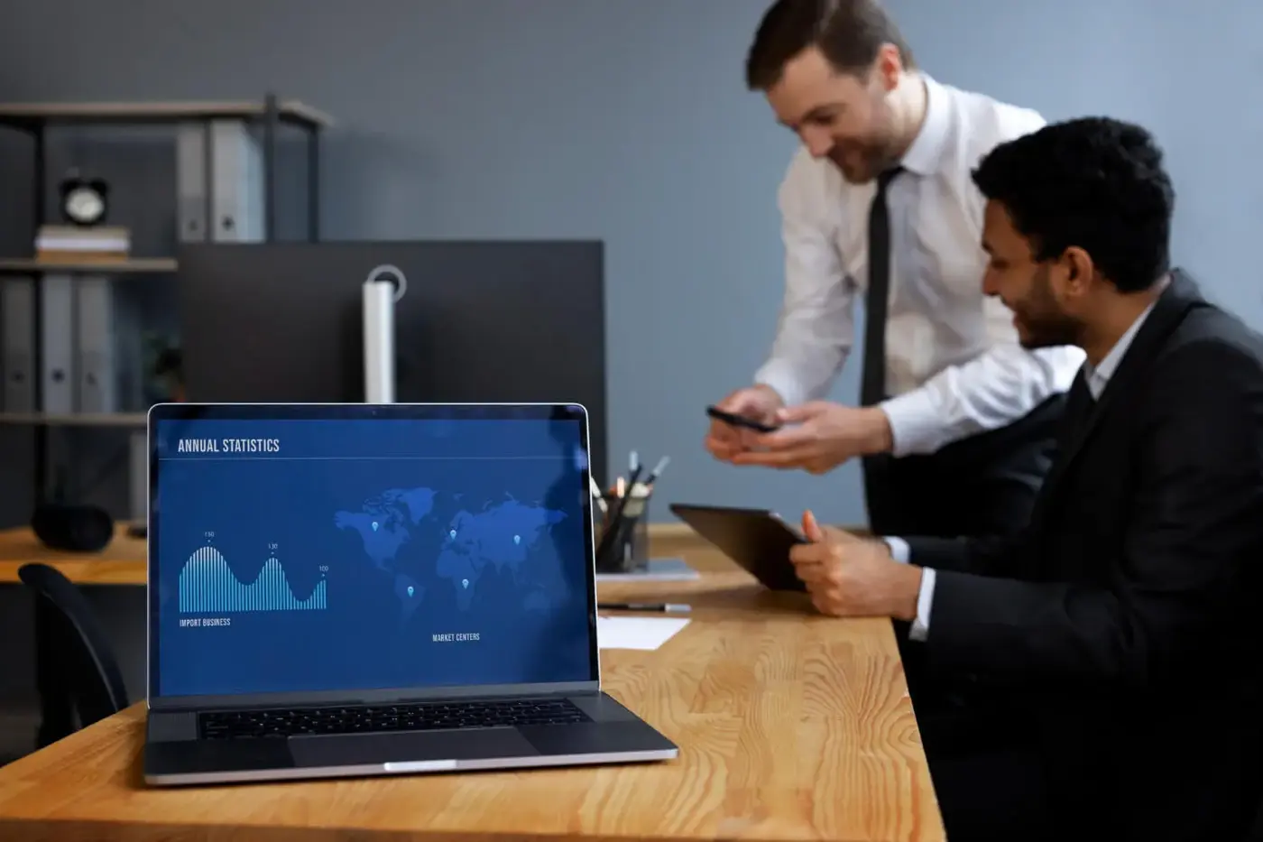 Colleagues reviewing a dashboard on a laptop
